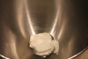 Room temperature Neufchâtel in chilled mixing bowl.