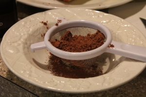 I use a little strainer for dusting cocoa powder. 